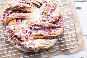 cranberry pecan braided bread swirled on cooling sheet