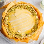 Baklava vanilla honey pistachio cheesecake on neutral background