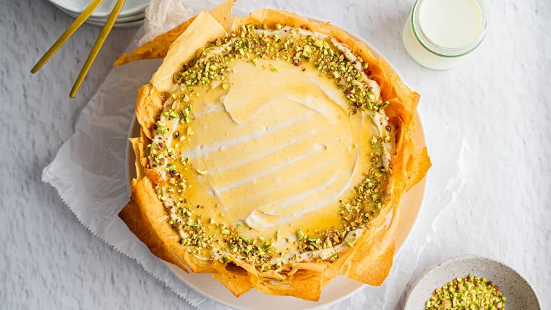 Baklava vanilla honey pistachio cheesecake on neutral background