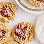 Cookies with Fruit topping and icing on neutral background with gauzy napkin