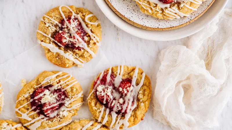 Cookies with Fruit topping and icing on neutral background with gauzy napkin