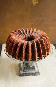 pecan bundt cake from Anne Byrn on cake stand with neutral background